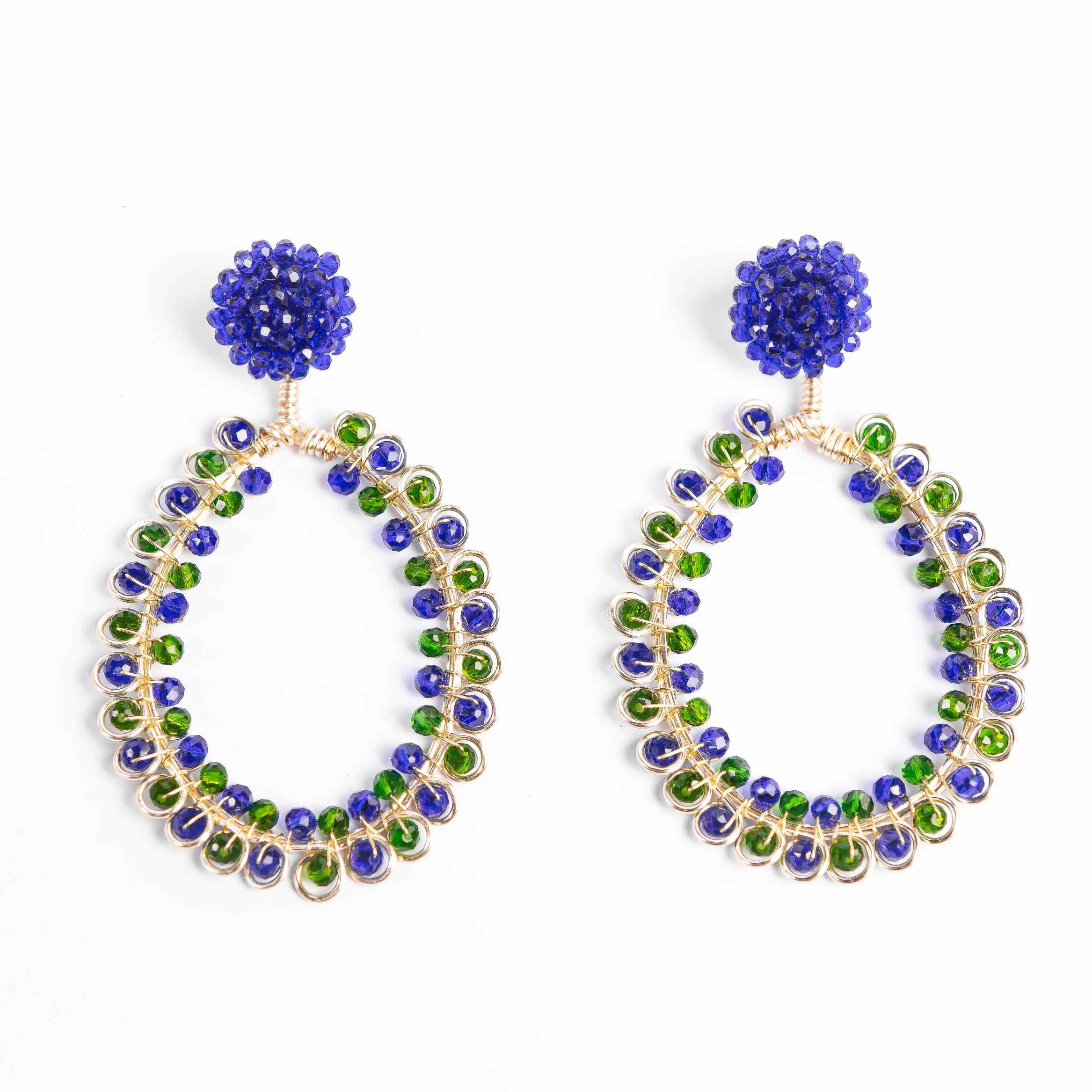 Pair of hoop earrings with blue and green gemstones on a white background