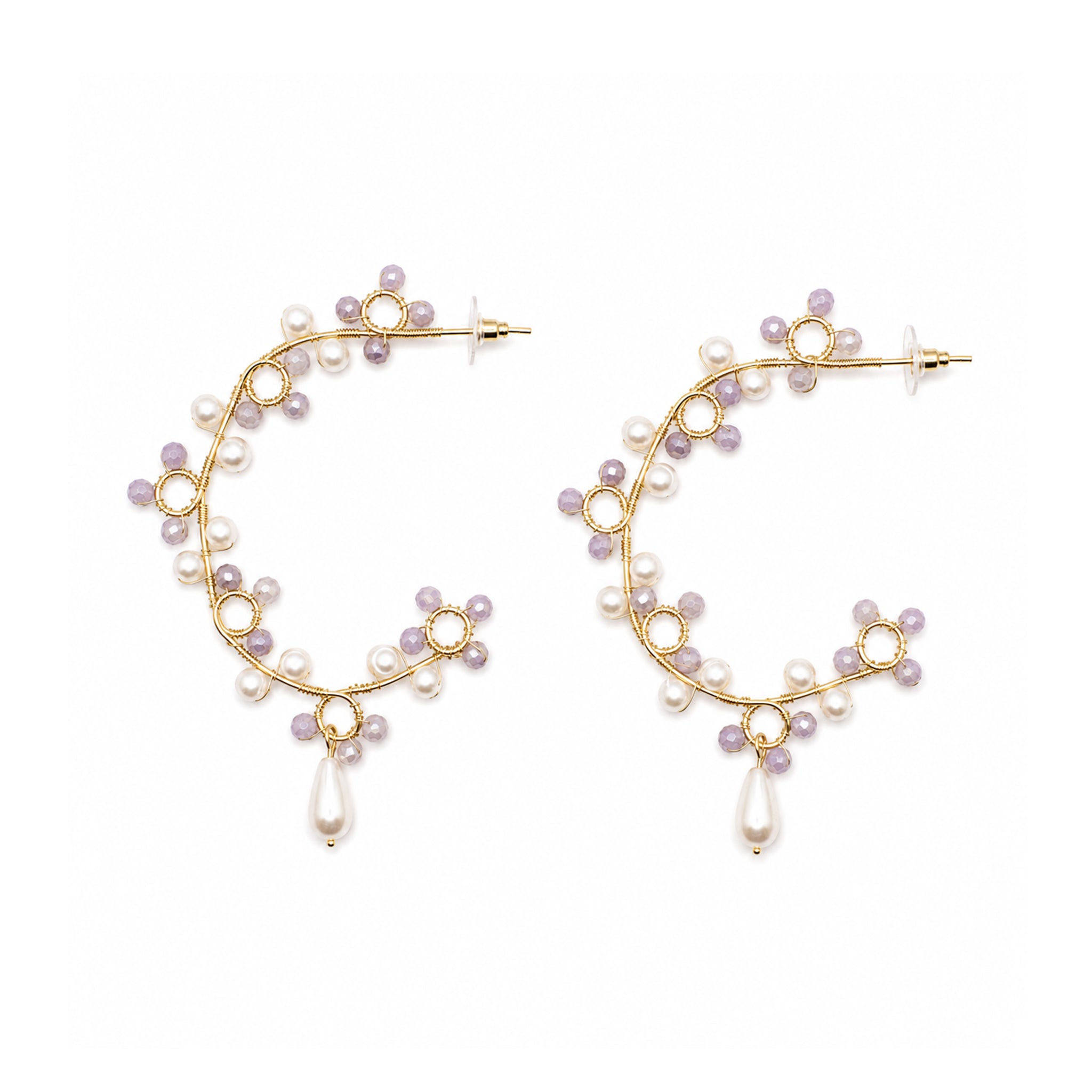 Gold hoop earrings with pearl beads on a white background