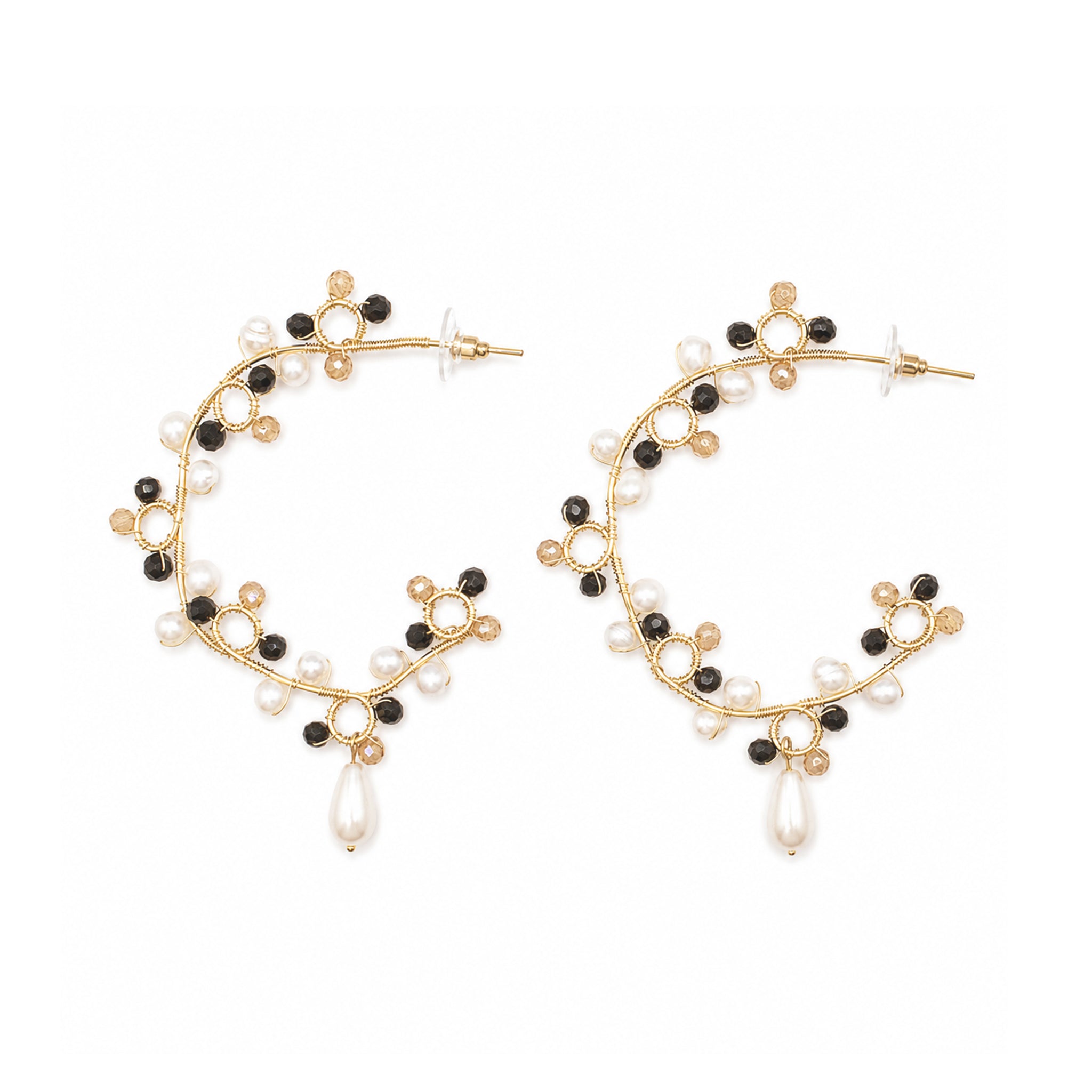Gold hoop earrings with black and white bead accents on a white background