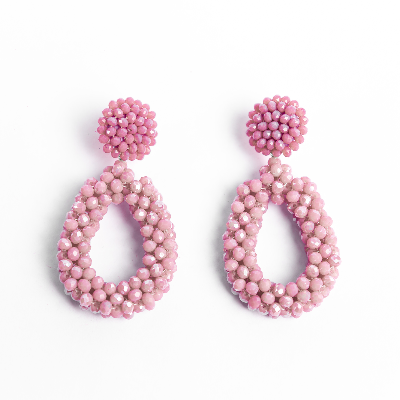 Pair of pink beaded earrings on a white background