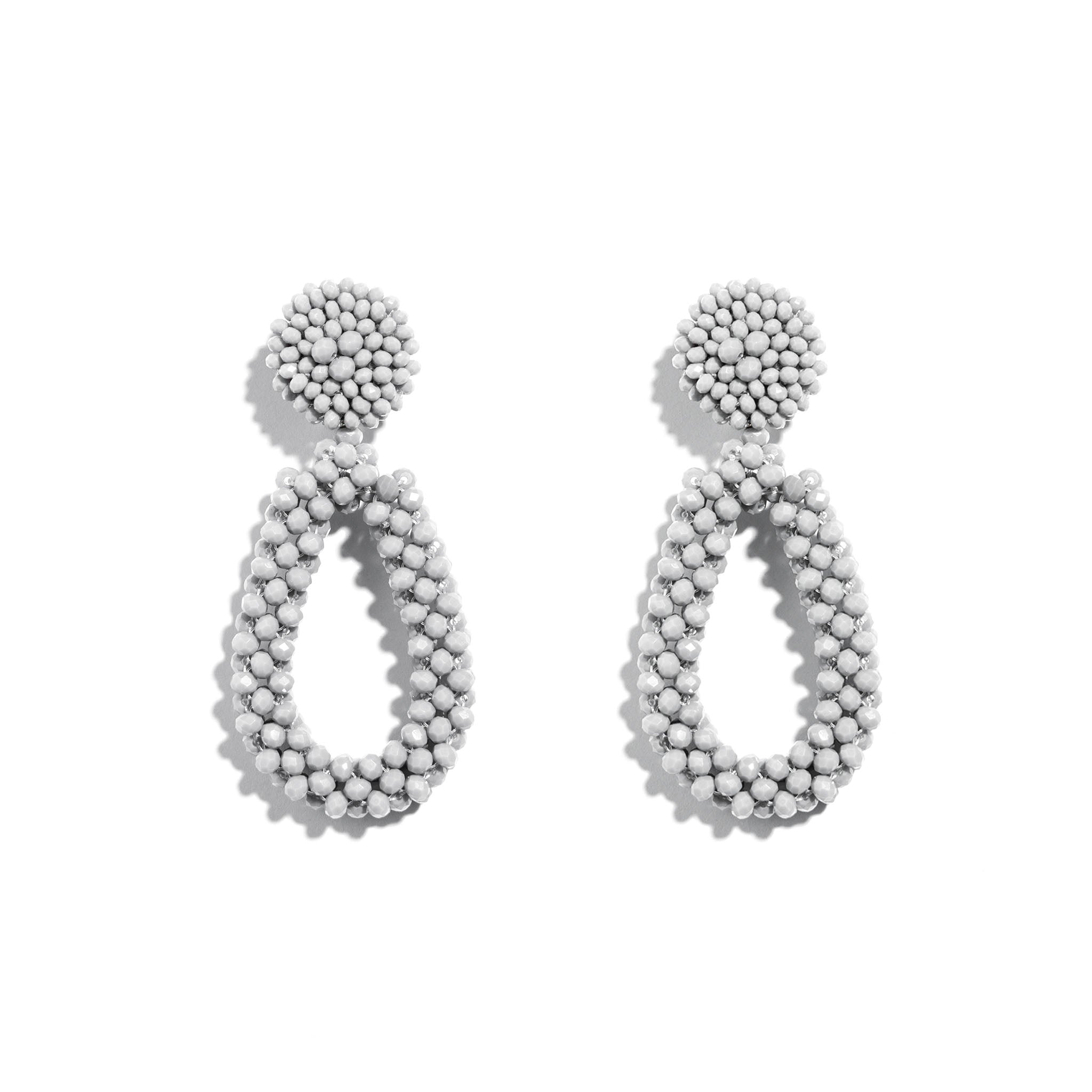 Pair of white beaded earrings on a white background