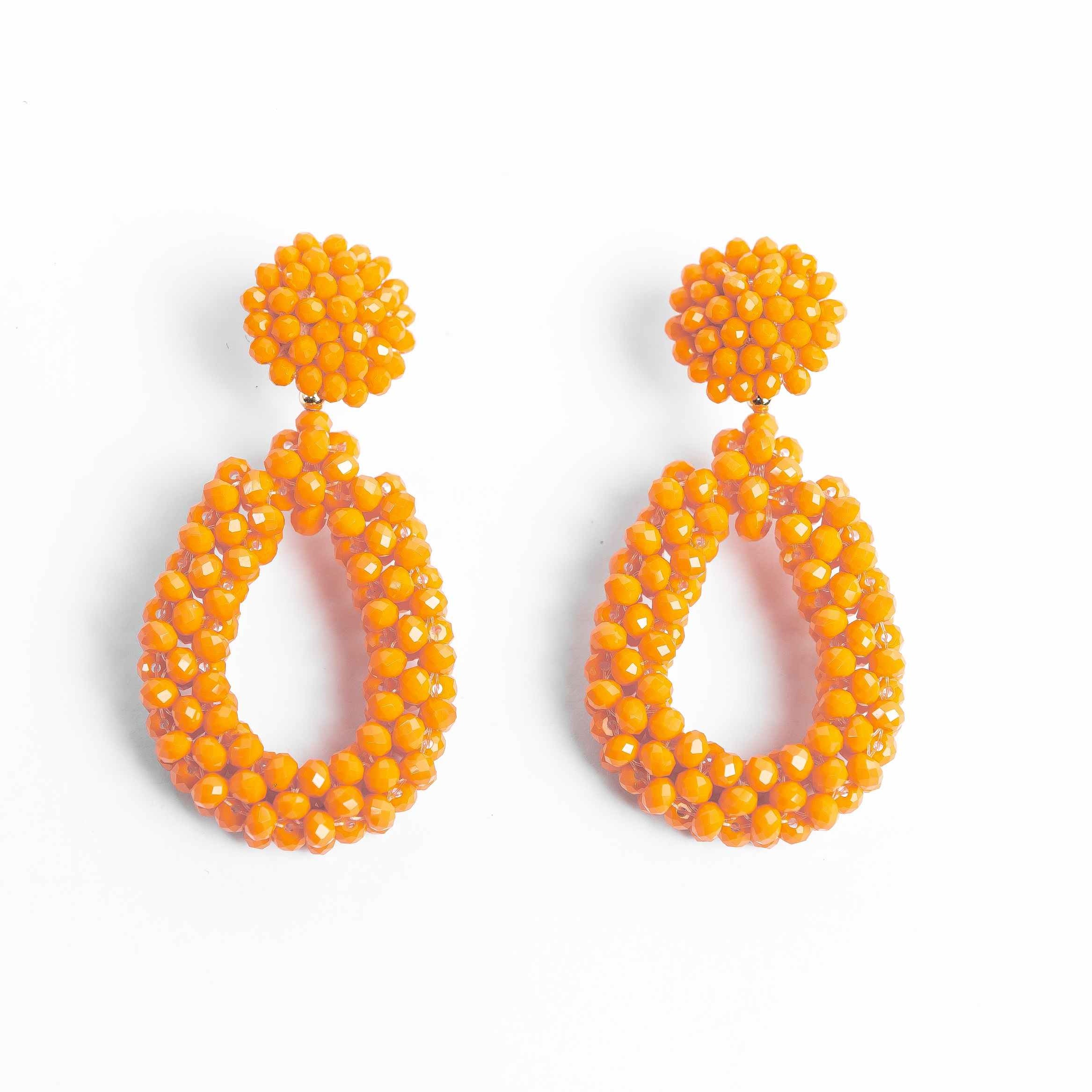 Pair of orange beaded earrings on a white background