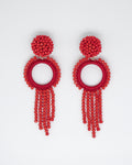 Red beaded earrings on a light gray background