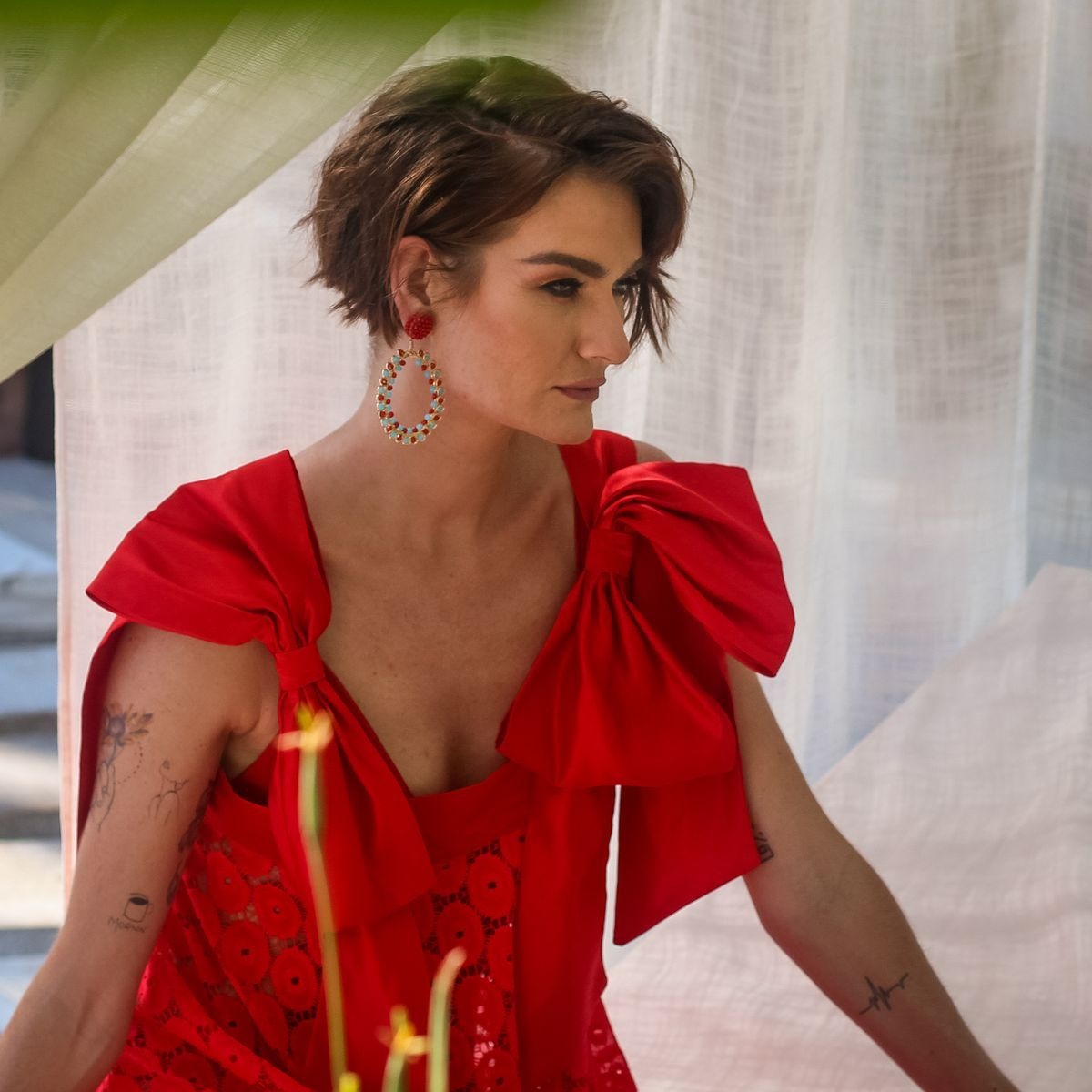 Women wearing a red dress and big hoops crystal earrings color red with green